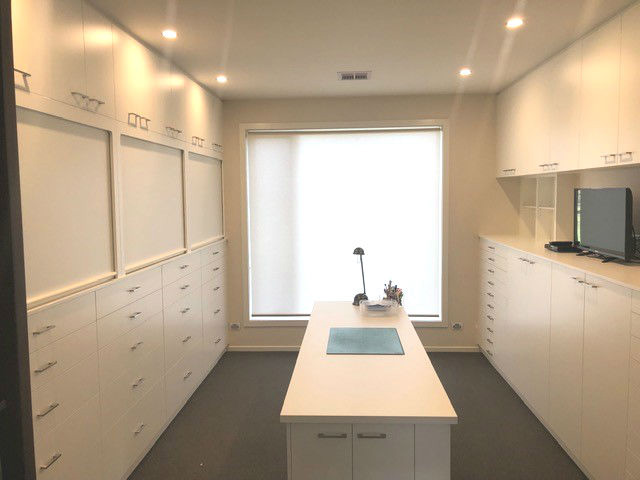 Craft room storage cabinetry with built in desk