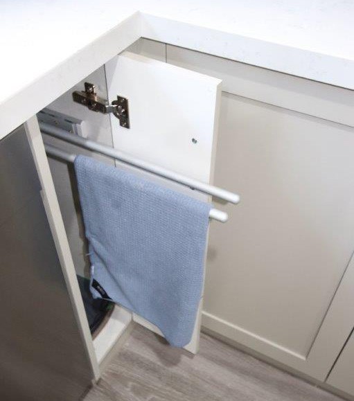 Pull out tea towel rail installed inside a kitchen cabinet