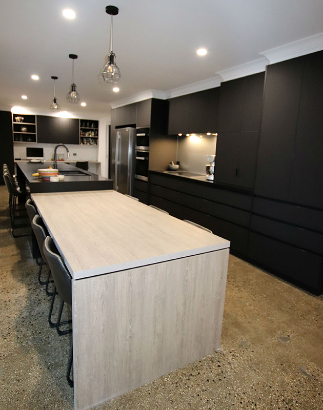 Modern black kitchen with matt finish cabinetry