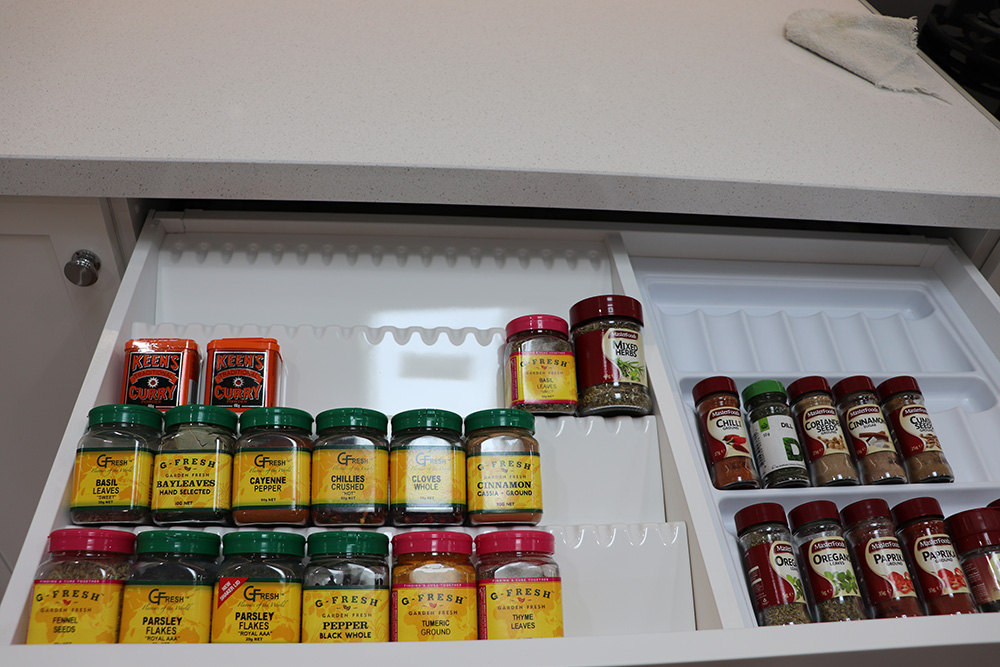 Spice storage drawer with jar inserts and organised herbs