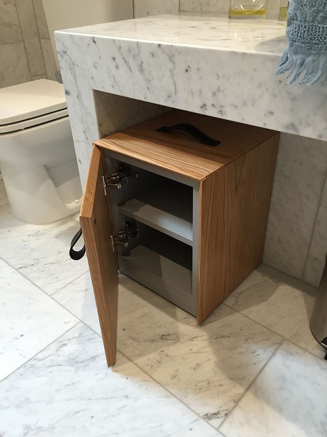Custom vanity cabinet with detailed joinery and stone top