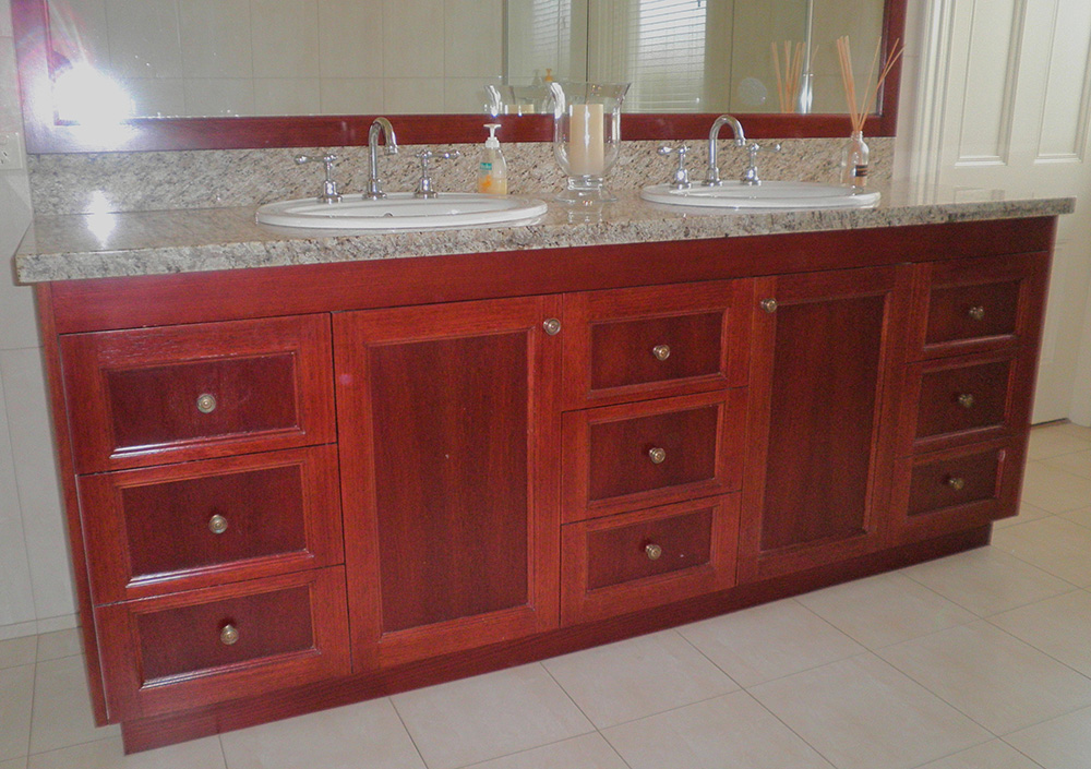 Traditional timber vanity with profiled doors and stone top