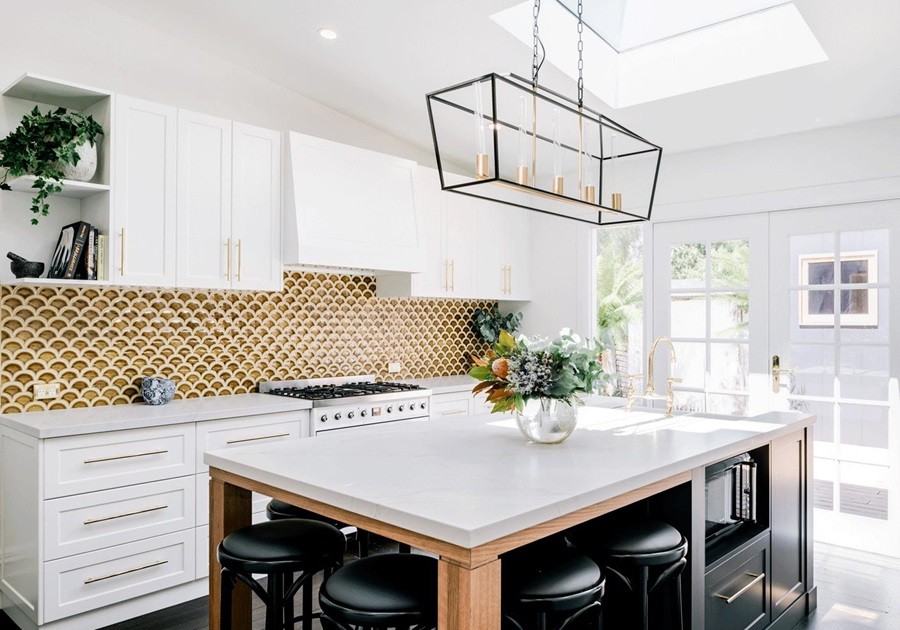White shaker kitchen with gold fish scale tile splashback and timber island detail