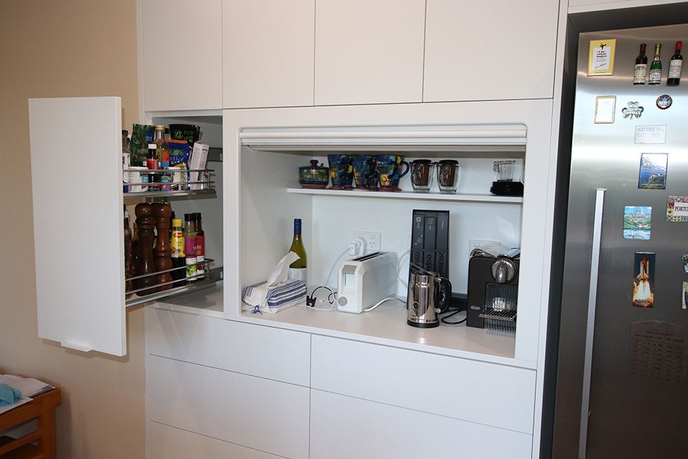 Pantry appliance station with tambour door and pull out spice storage