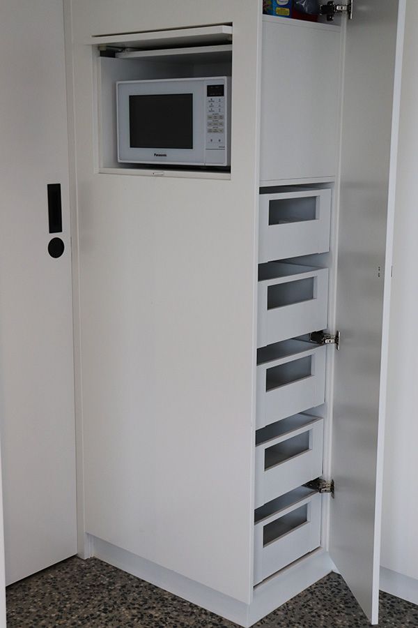 Tall pantry unit with internal drawers and microwave shelf