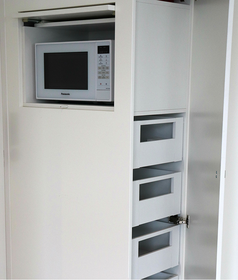 Clever hidden microwave storage in a pantry